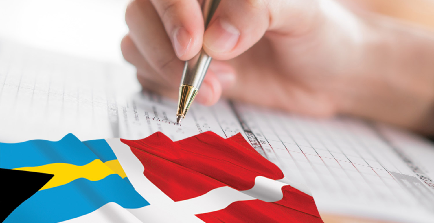 Close up of hand completing a checklist alongside a flag