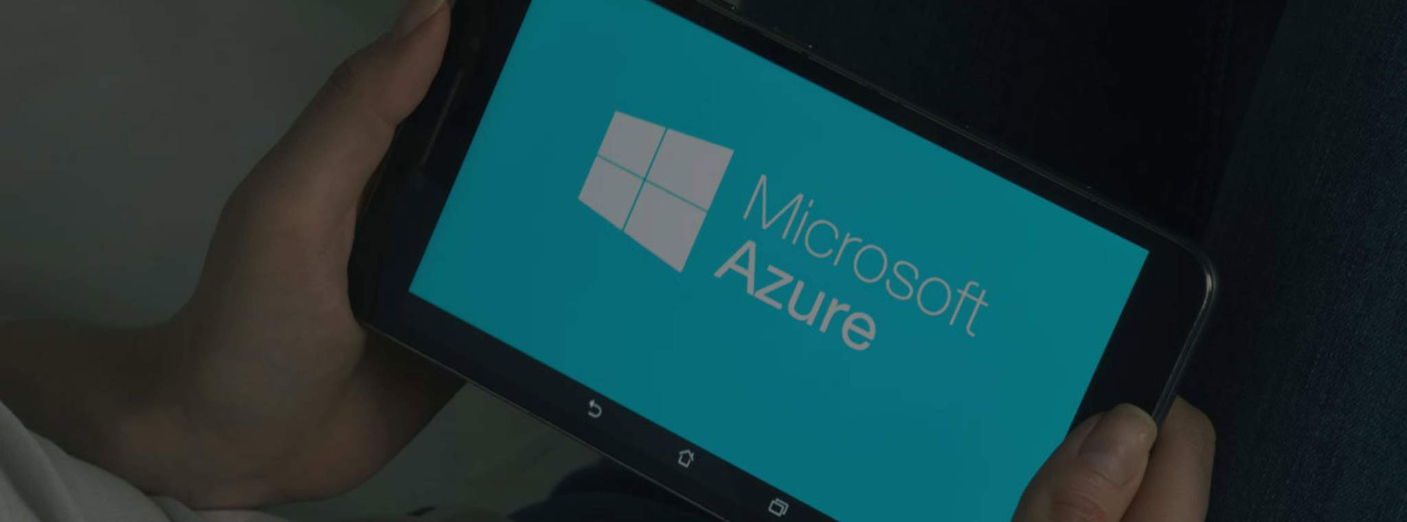 Man holding mobile device logging in to Azure