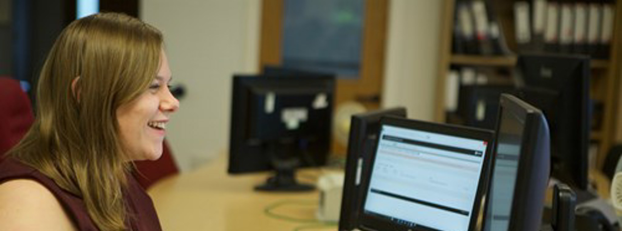 A photo of Leigh Graves at her desk working