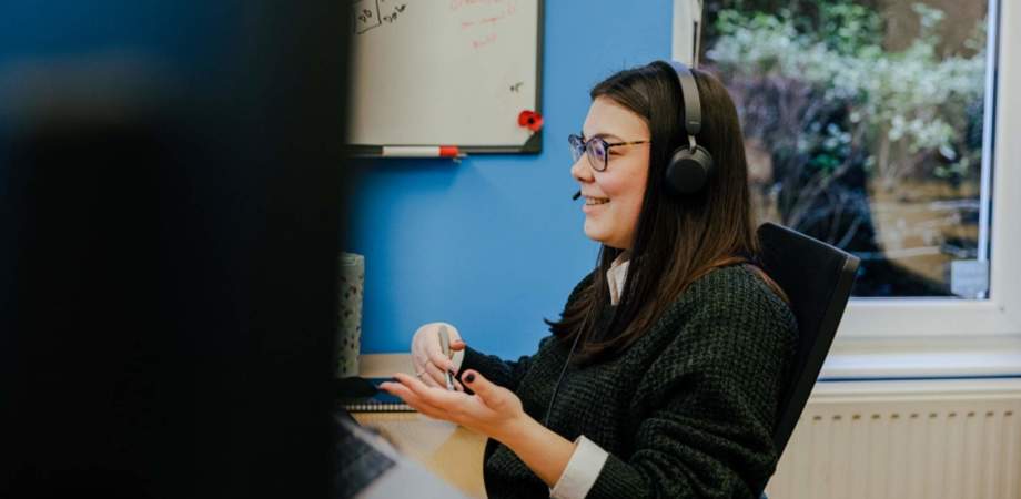 A photo of Katerina on a Teams call sat at her desk