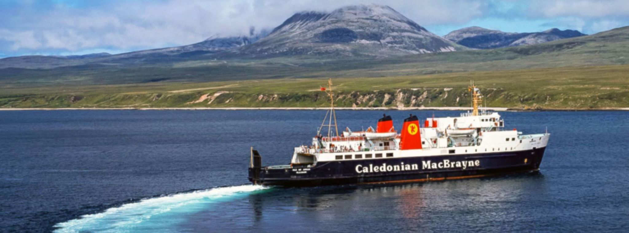 A photo of cars on a Caledonian MacBrayne ferry deck with the Shetland countryside in the background