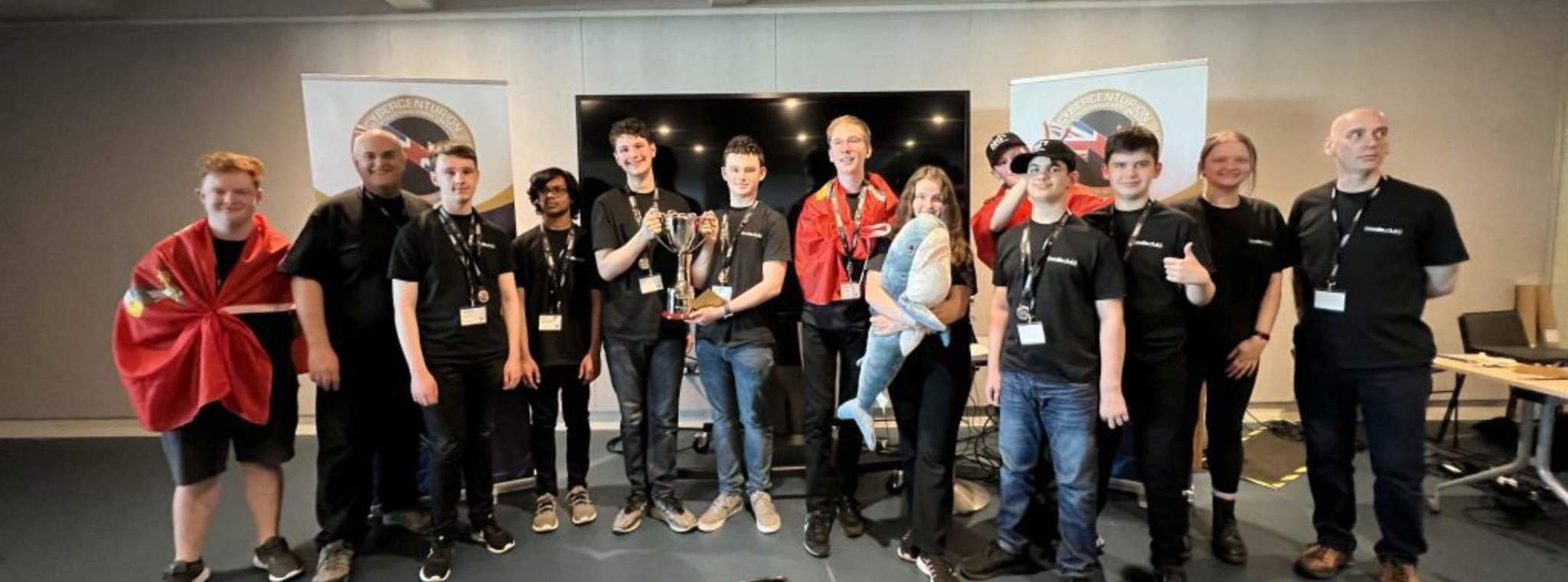 Coding Club team members posing for a photo with their trophy