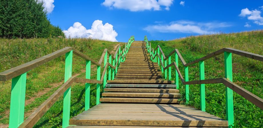 An image of stairs leading to a sky with clouds in the sky