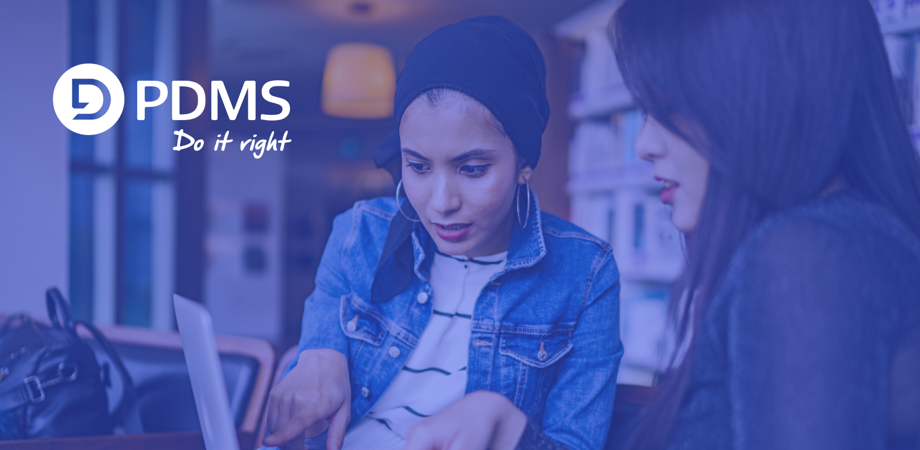 Photo of two women working on a shared laptop with the PDMS logo