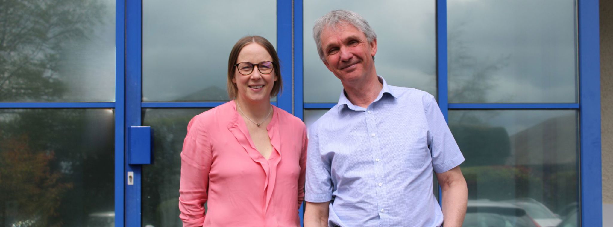 A photo of Catriona Watt and Chris Gledhill outside the PDMS office