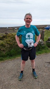 Chris Gledhill standing in countryside after finishing his leg of Race the Sun
