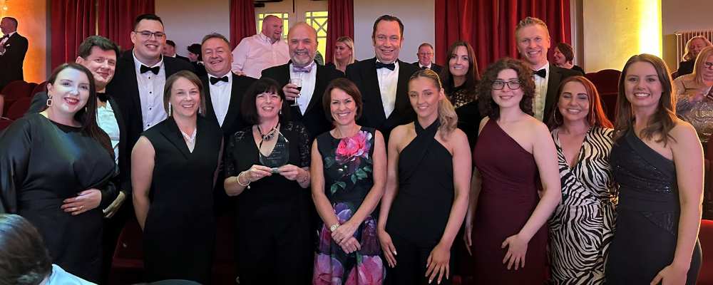 PDMS staff smiling with their Company of the Year award