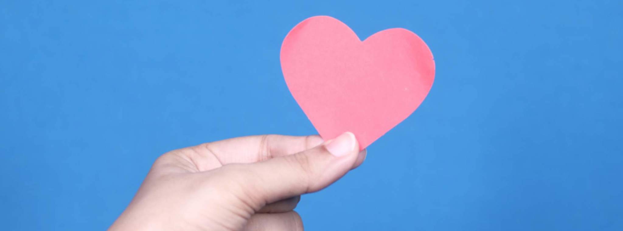 A photo of a paper heart held in a hand 