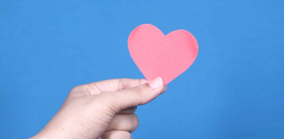 A photo of a paper heart held in a hand 