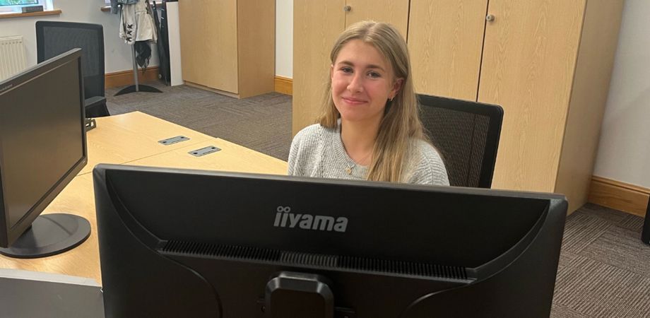 Work experience student Rosie Parsons sat at her desk at PDMS