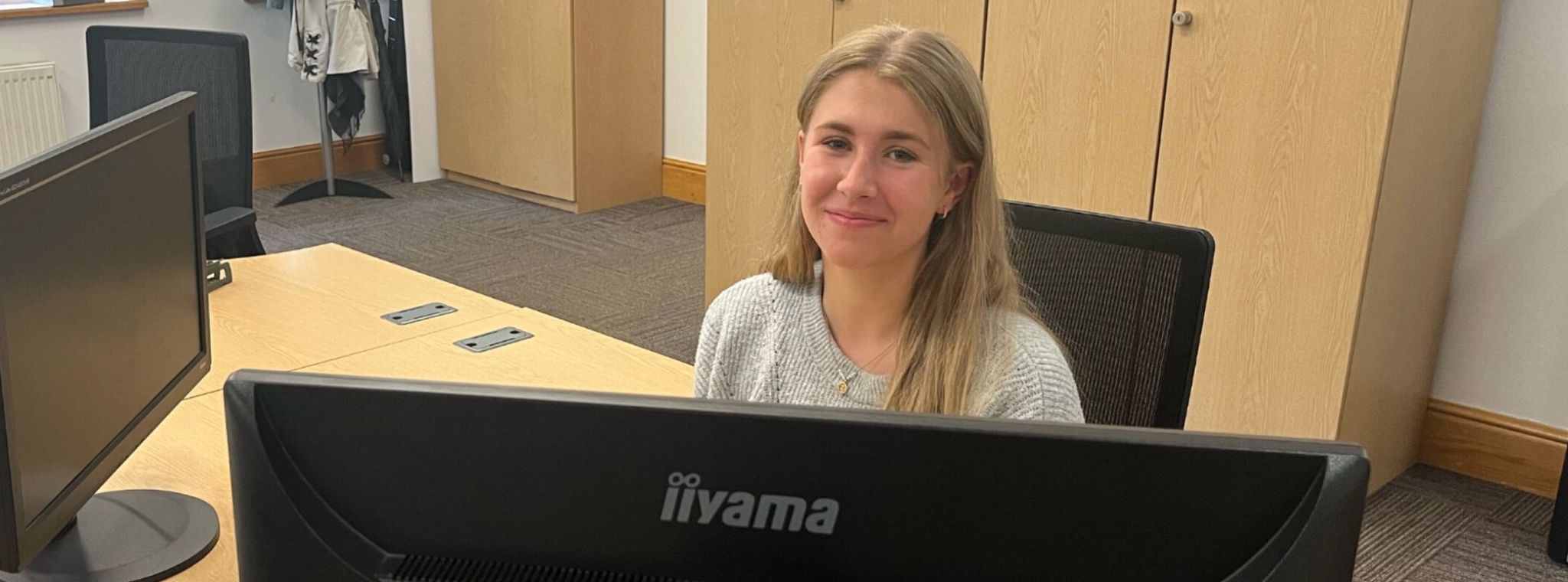 Work experience student Rosie Parsons sat at her desk at PDMS