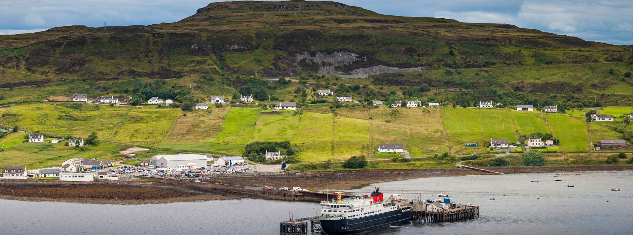 A panoramic photo of a ferry docked in the Shetland Islands