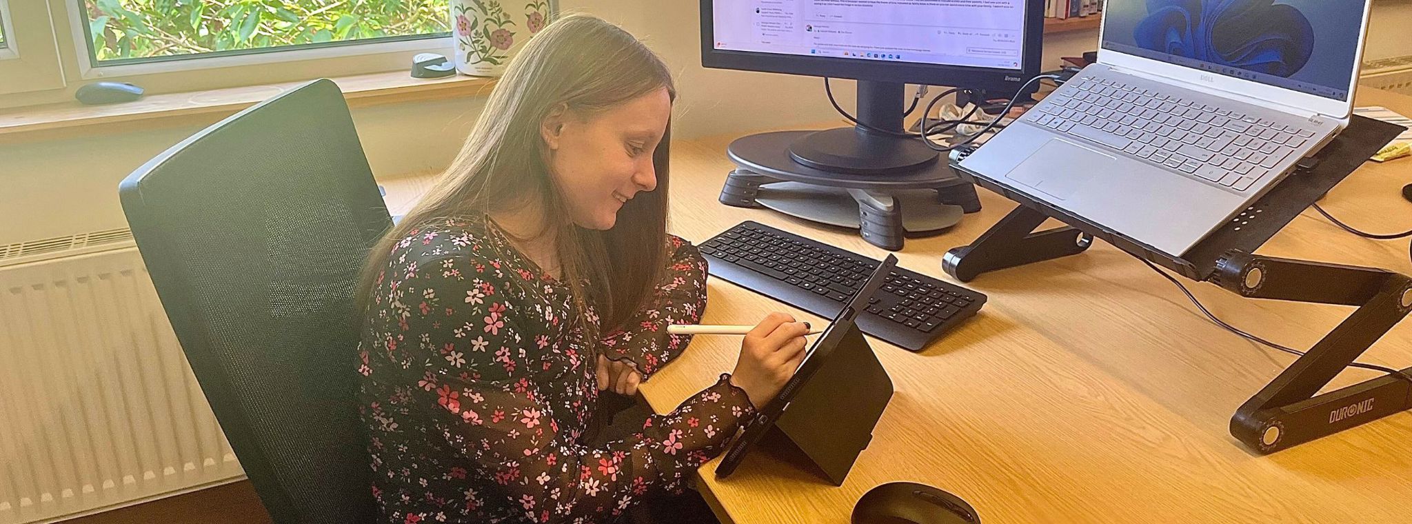 A photo of work experience student Zoe Durcan working at her desk