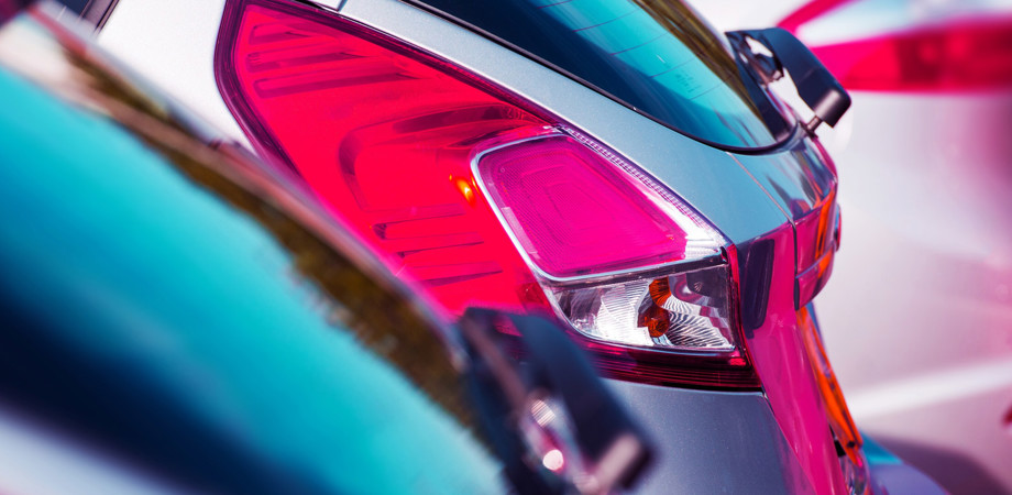 A close-up of rear lights on parked cars