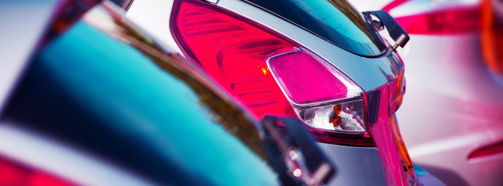 A close-up of rear lights on parked cars