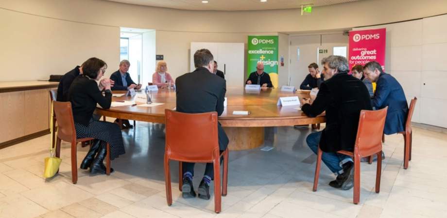 Roundtable participants sat around table having a discussion