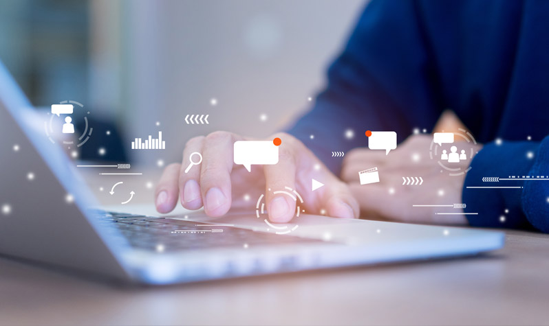 Close up of man using a laptop with futuristic of icons of internet network technology and business